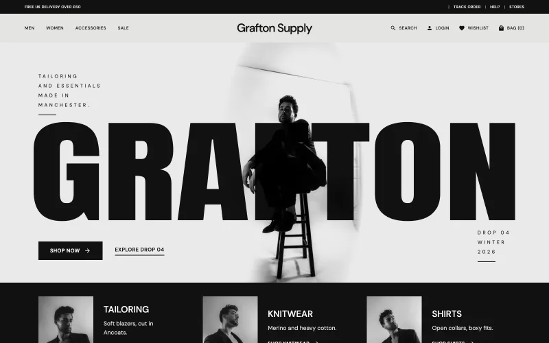 Grafton Supply homepage: GRAFTON in huge black condensed letters with a model in a black suit sitting on a stool in front of it, in a black and white studio, over a black strip of tailoring, knitwear and shirts.