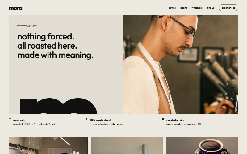 mora homepage: nothing forced, all roasted here, made with meaning in lowercase type on warm stone, a giant cropped m, a photo of a smiling barista, and opening hours.