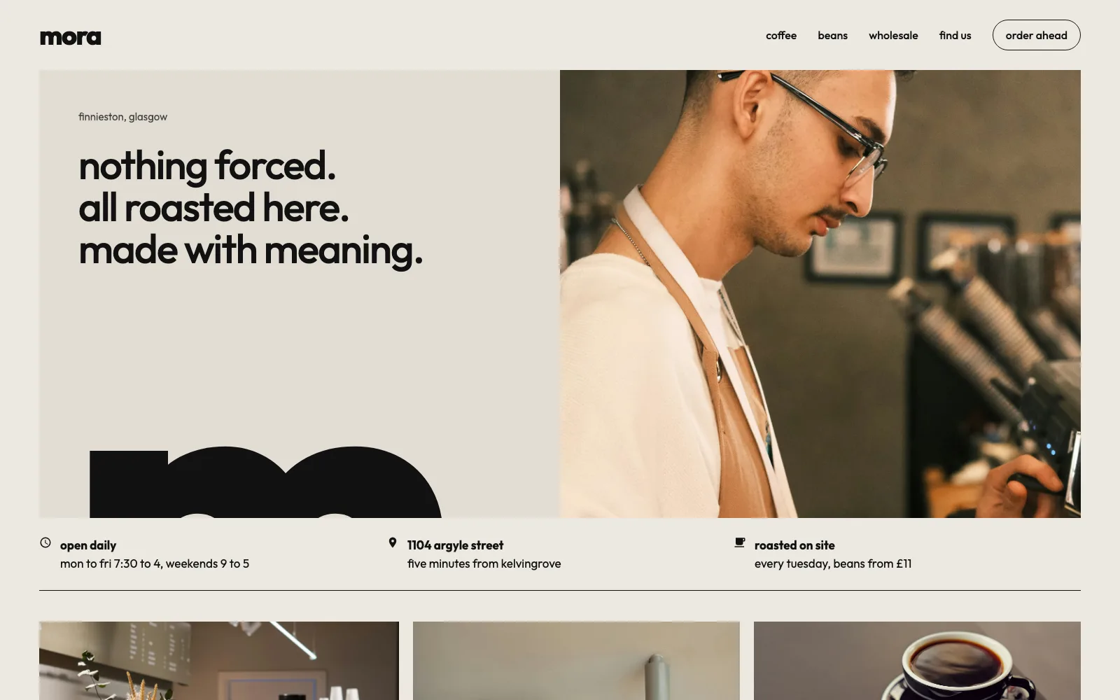 mora homepage: nothing forced, all roasted here, made with meaning in lowercase type on warm stone, a giant cropped m, a photo of a smiling barista, and opening hours.