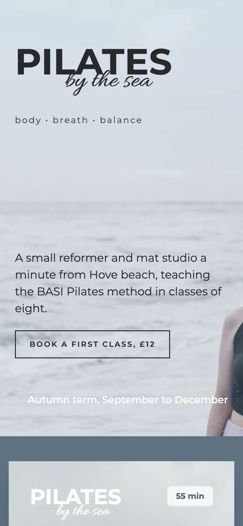 The Saltwater Pilates homepage: PILATES by the sea over a misty grey sea with a woman in a sports top looking out, then price and timetable cards on slate blue. example site on a phone.