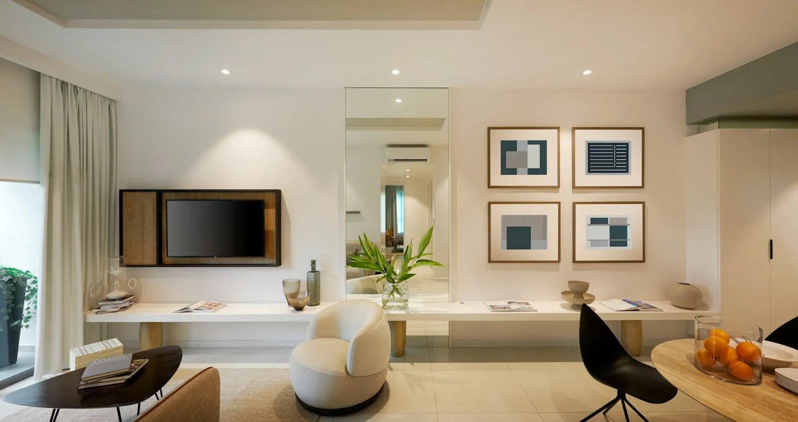 A bright living room in a new apartment with a white sofa and framed prints.